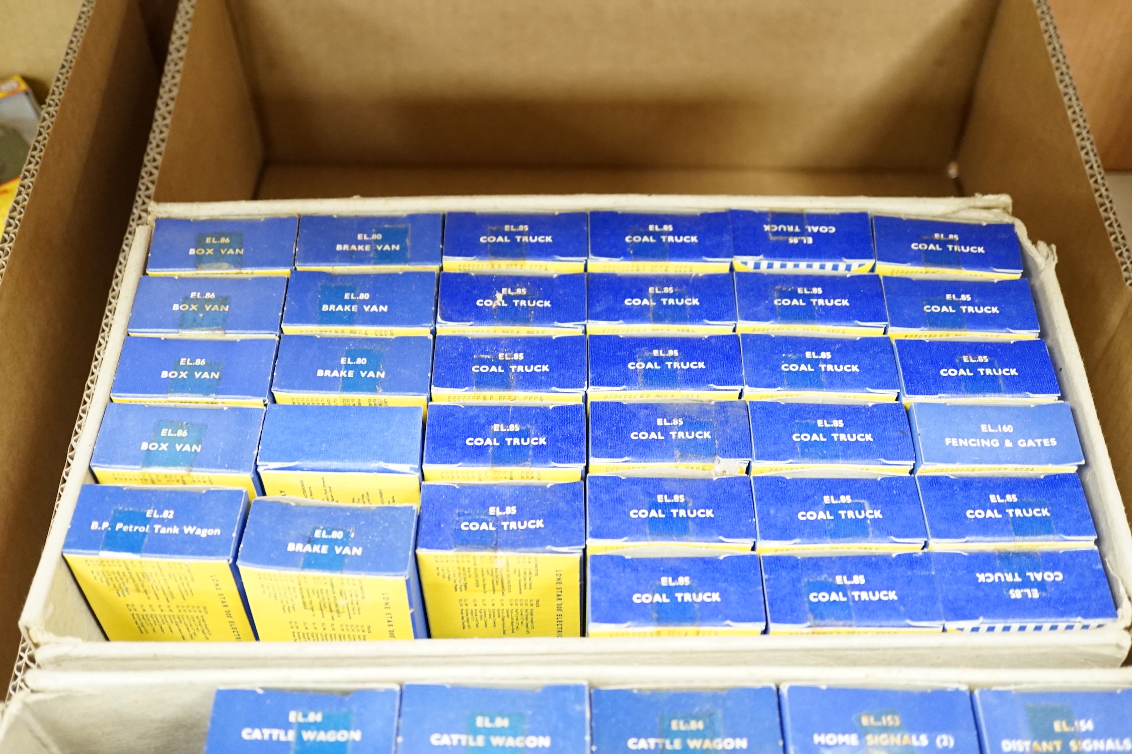A collection of Lone Star 000 gauge model railway, contained within two original trade boxes with most items, appearing boxed as new, comprising coal trucks, brake vans, petrol, tank, wagons, distance, signals, home, sig